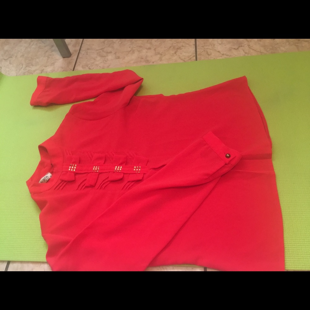 Salmon colored top with bow embellishments